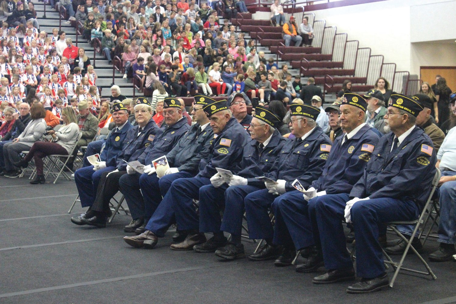 Several members of the American Legion Post No. 30 sit in the front row during the 14th Annual Veterans Day Celebration at Mountain Grove High School.
